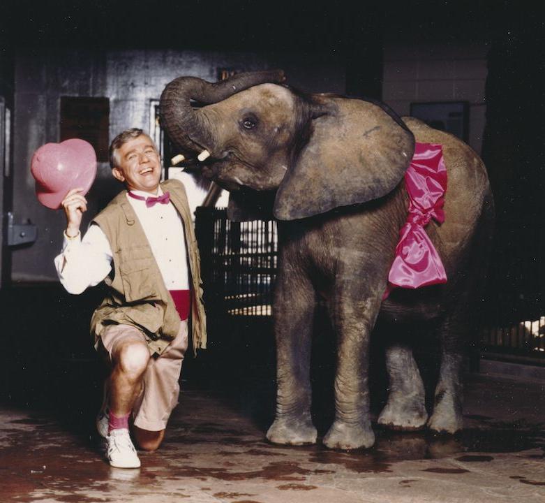 Representative Paul Schauer posing with an elephant