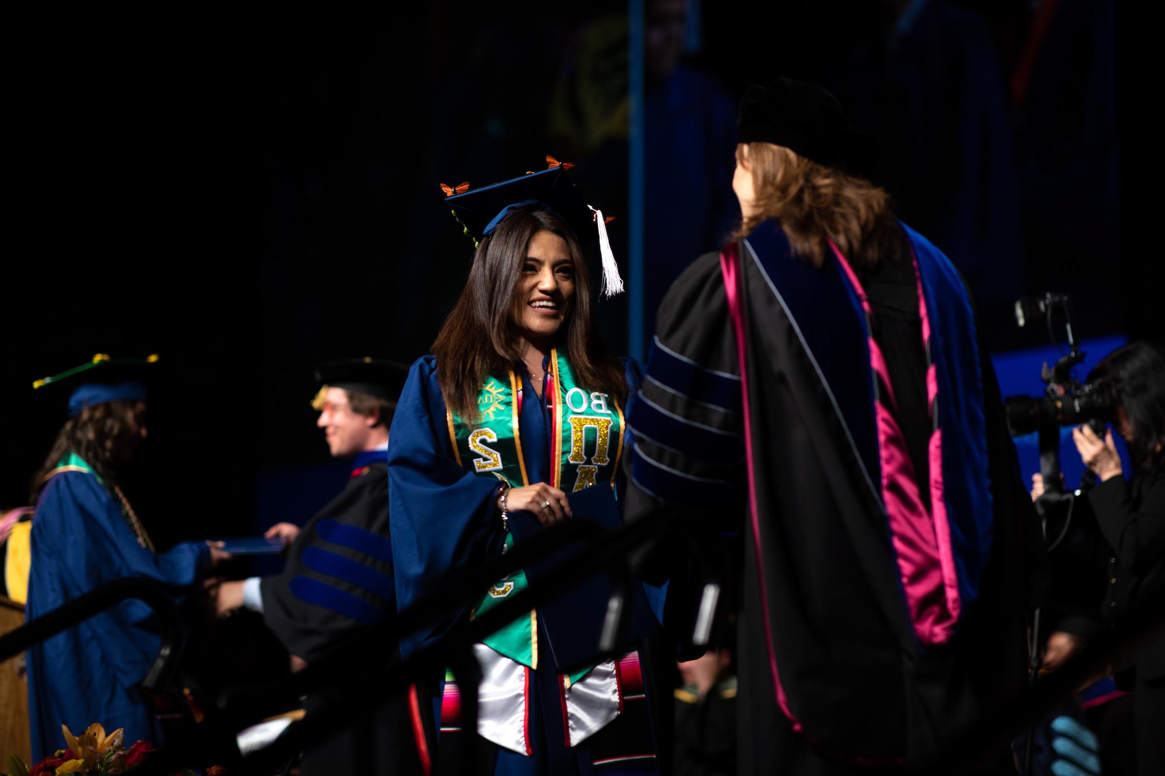 A MSU Denver Graduate shaking hands with a Department Chair